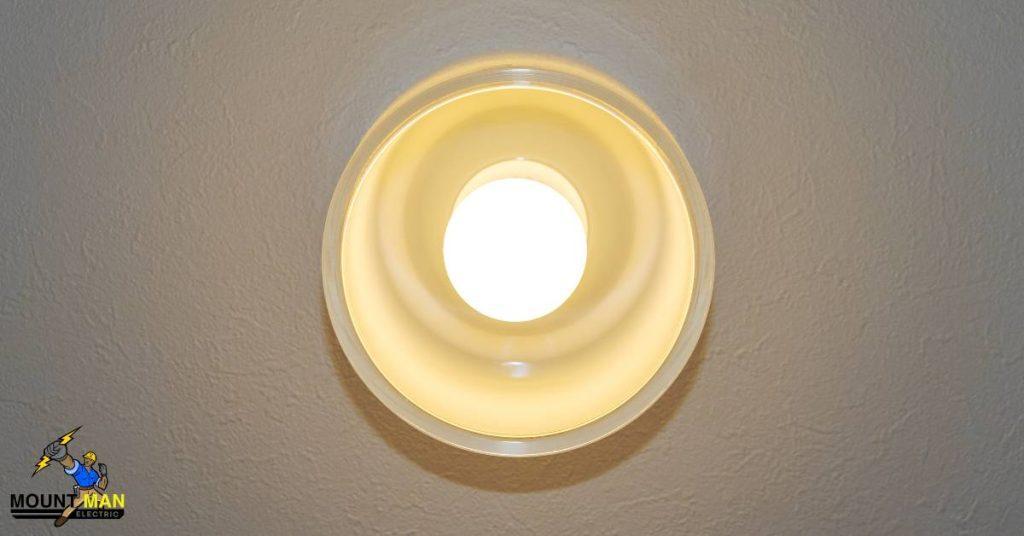 A light fixture hangs from the ceiling with the Mount Man logo in a corner