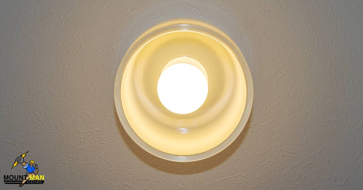 A light fixture hangs from the ceiling with the Mount Man logo in a corner